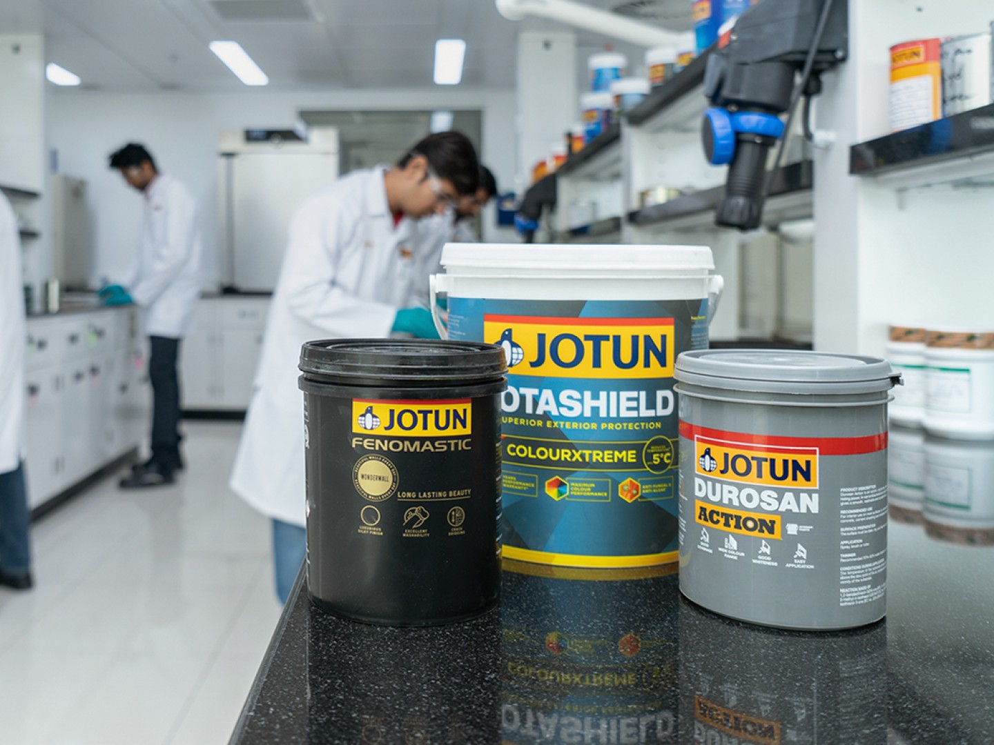 Paint cans with Jotun in production premises