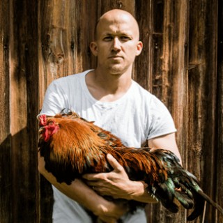 Man holding a rooster