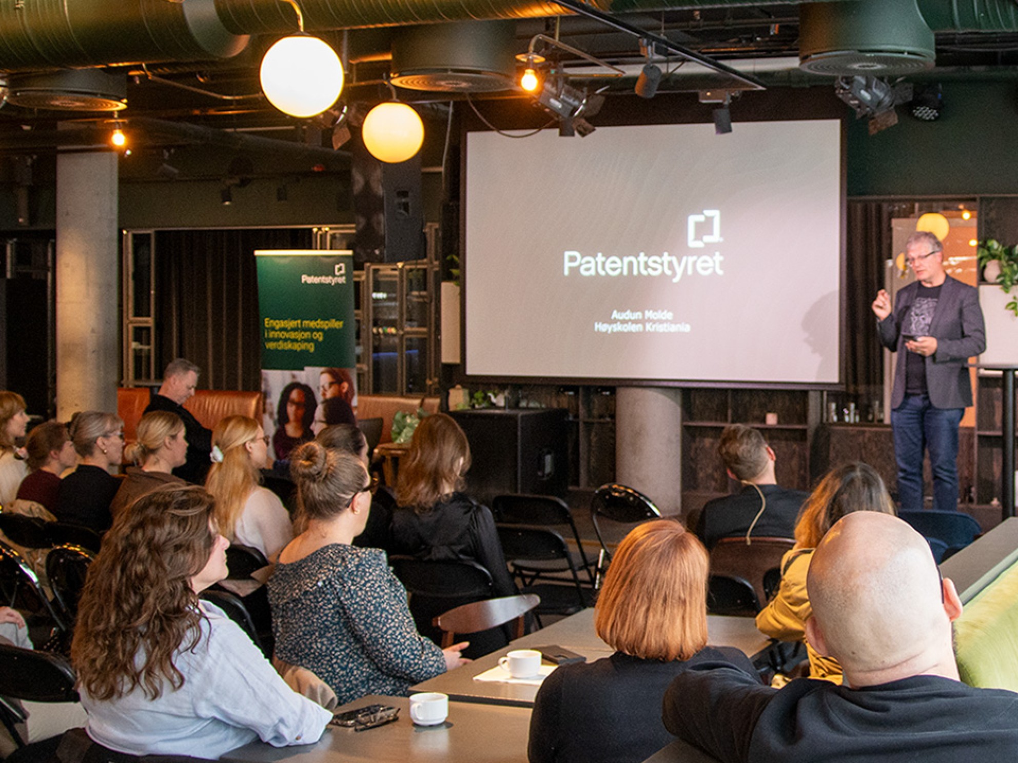 man on stage with many people in the audience