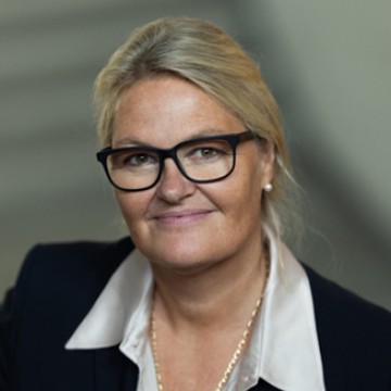 close-up of woman with blond hair and glasses