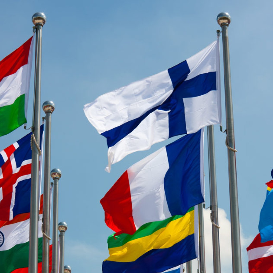 Flagpoles with flying flags from different nations.